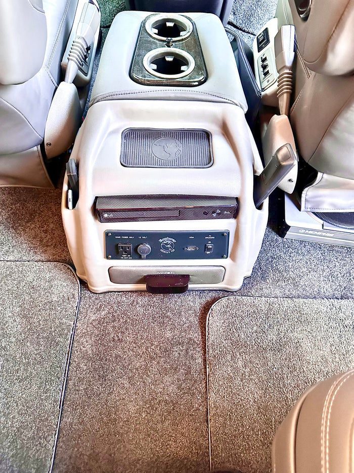 and bright cabin lighting.|Spacious RV rental interior featuring multiple rows of plush leather captain's chairs and large windows.|Spacious RV rental interior featuring black leather captain's chairs