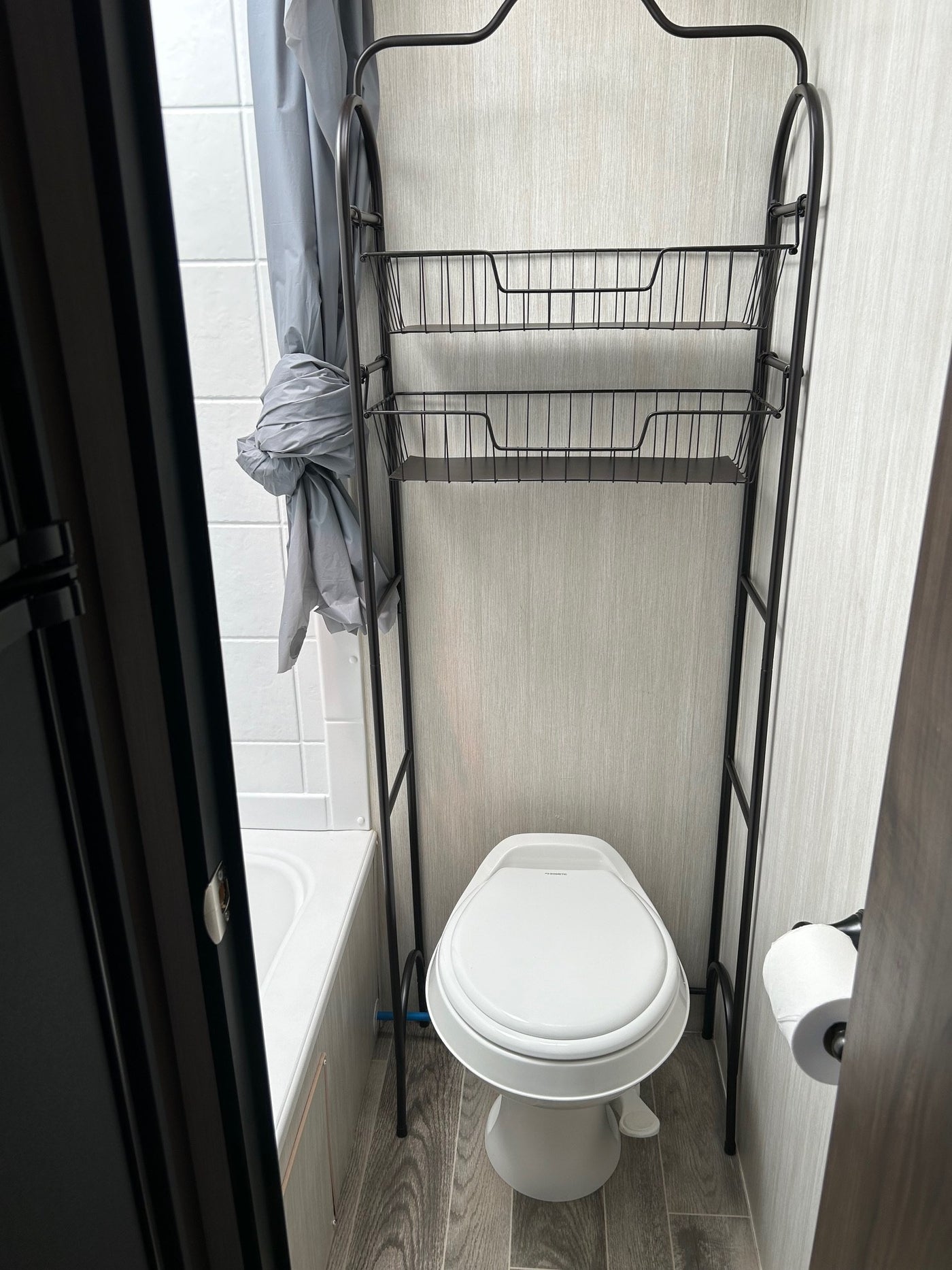 and an over-the-toilet storage unit.|RV rental's compact kitchen: microwave — photo 3