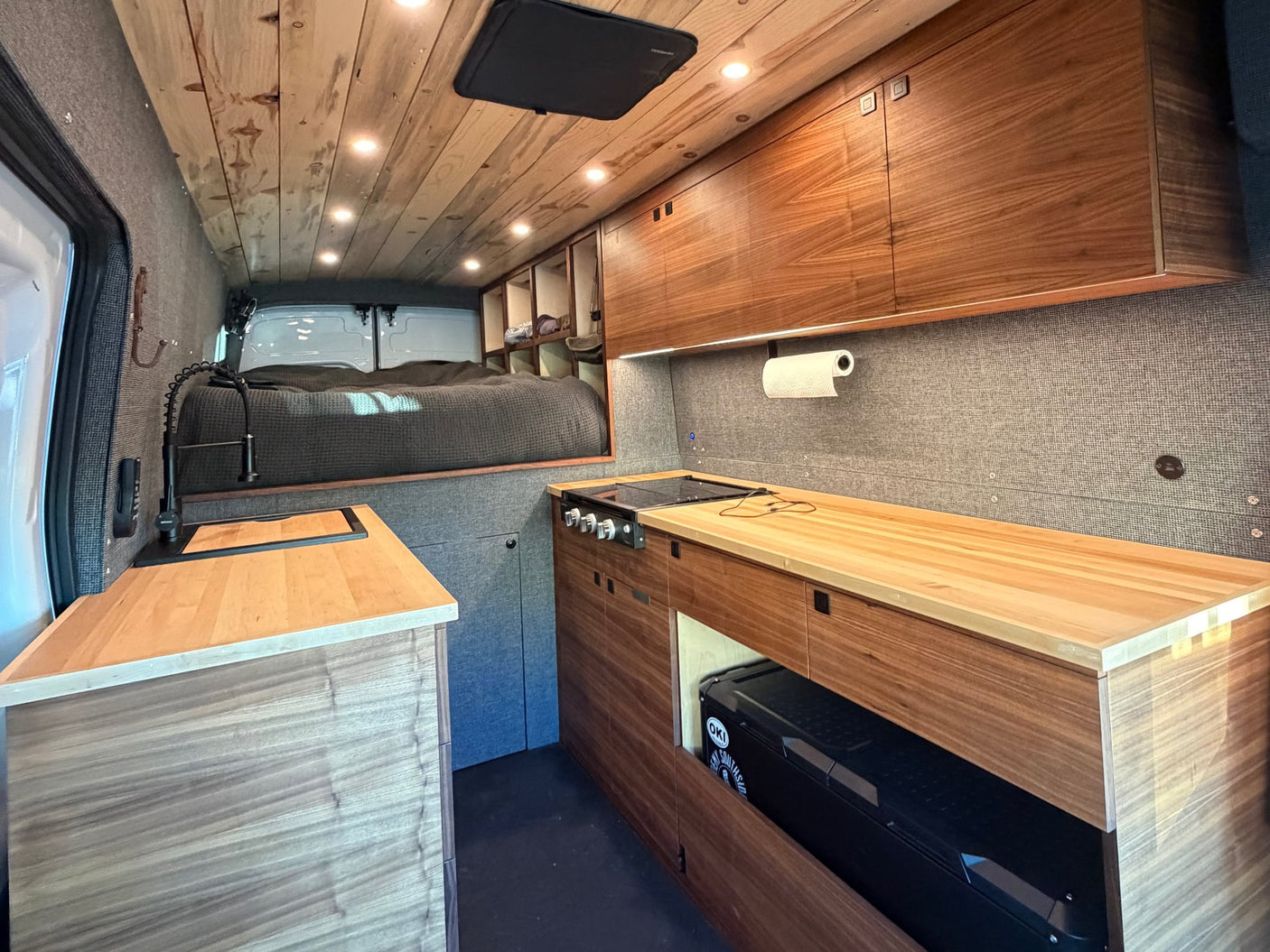 parked by scenic mountains.|Spacious RV rental interior with a comfortable bed