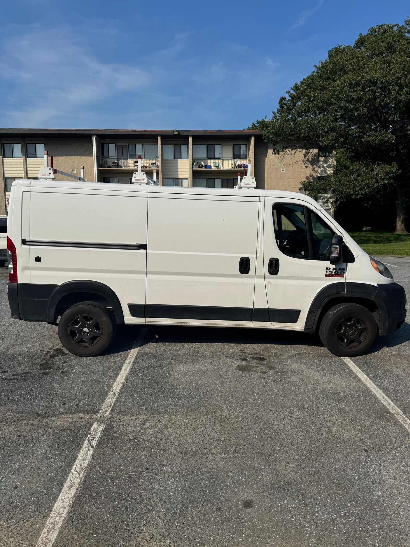 with roof rack and Maryland license plate 4GM6845. Potential for rv rental.|Rear view of a white Ram ProMaster cargo van