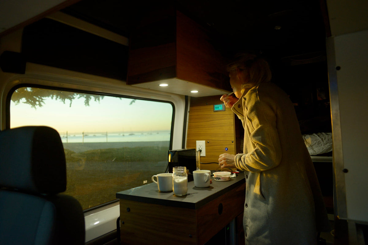 and a scenic outdoor view through the rear doors.|Inside this **rv rental** — photo 19