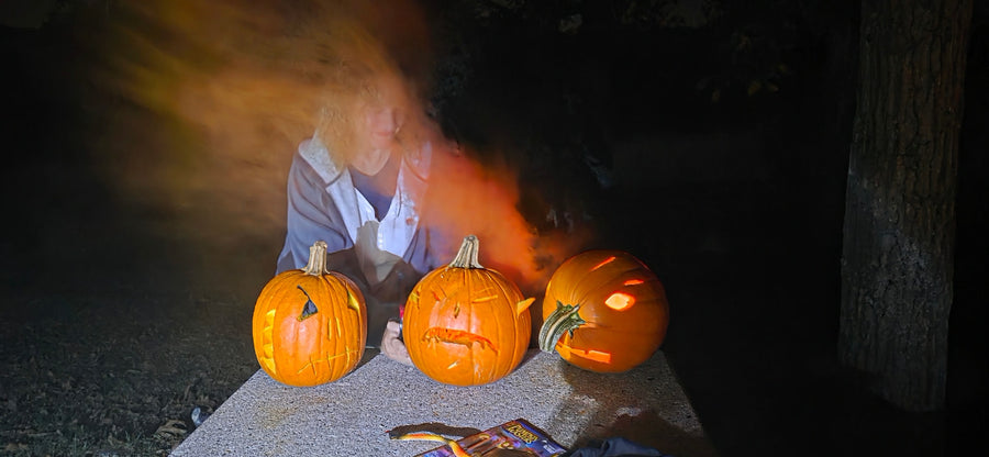Ghostly figure and carved jack-o'-lanterns light up a spooky Halloween night scene. Ideal fun for your RV rental getaway.