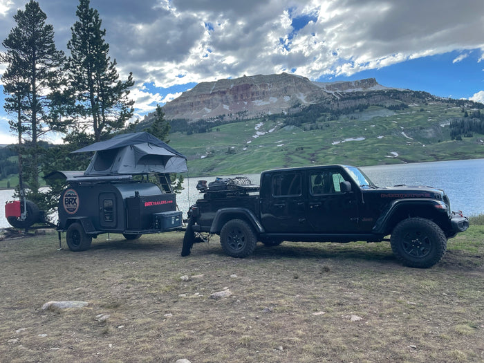high on snowy Beartooth Pass.|Sunrise beach camping with a BRX teardrop RV rental