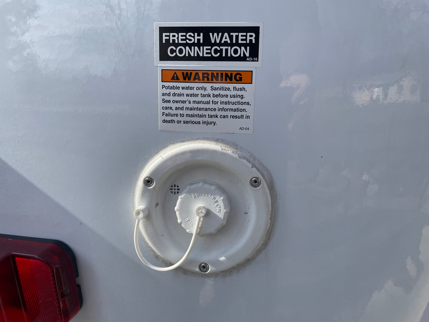 RV rental: fresh water connection and warning for potable tank sanitization, essential for safe use.