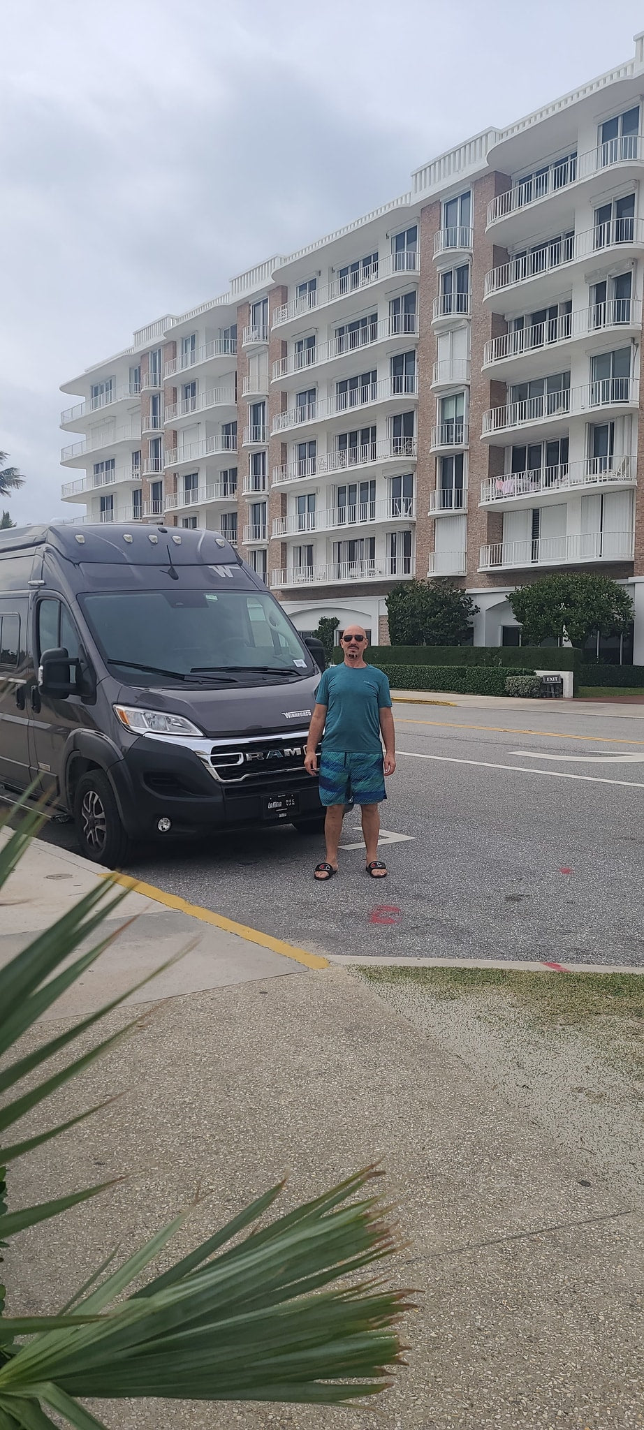 Man stands next to his gray RV rental van