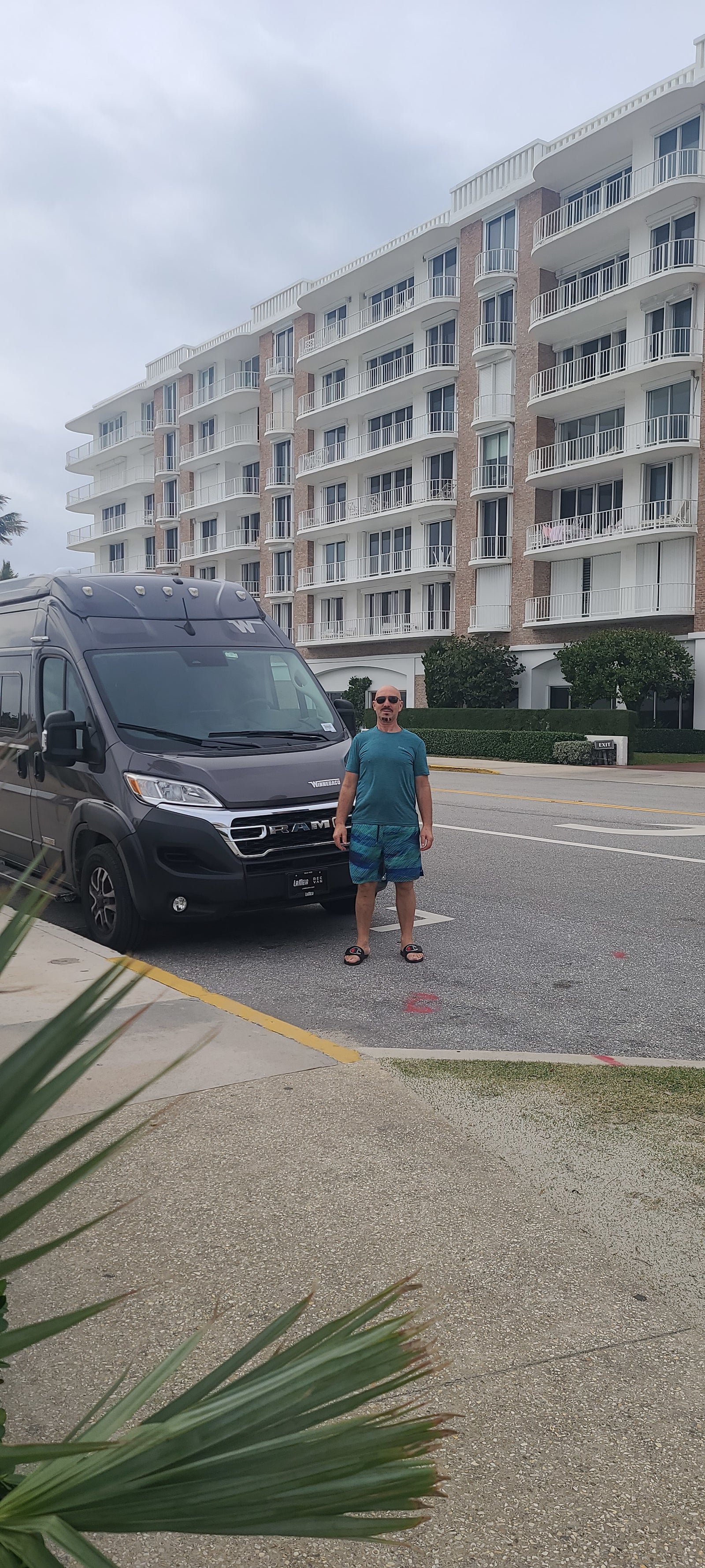 Man stands next to his gray RV rental van