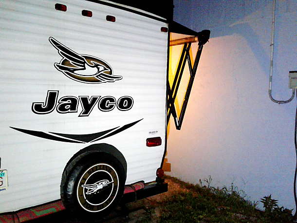 an SUV nearby.|White Jayco travel trailer parked outdoors
