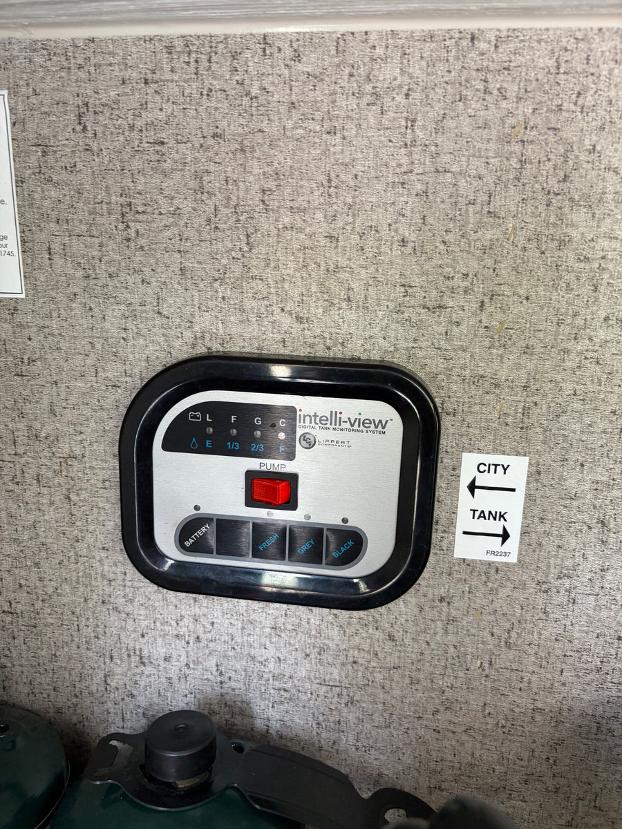 RV rental control panel: Intelli-view digital tank monitor for fresh, grey, black water, and battery levels. Includes pump switch.