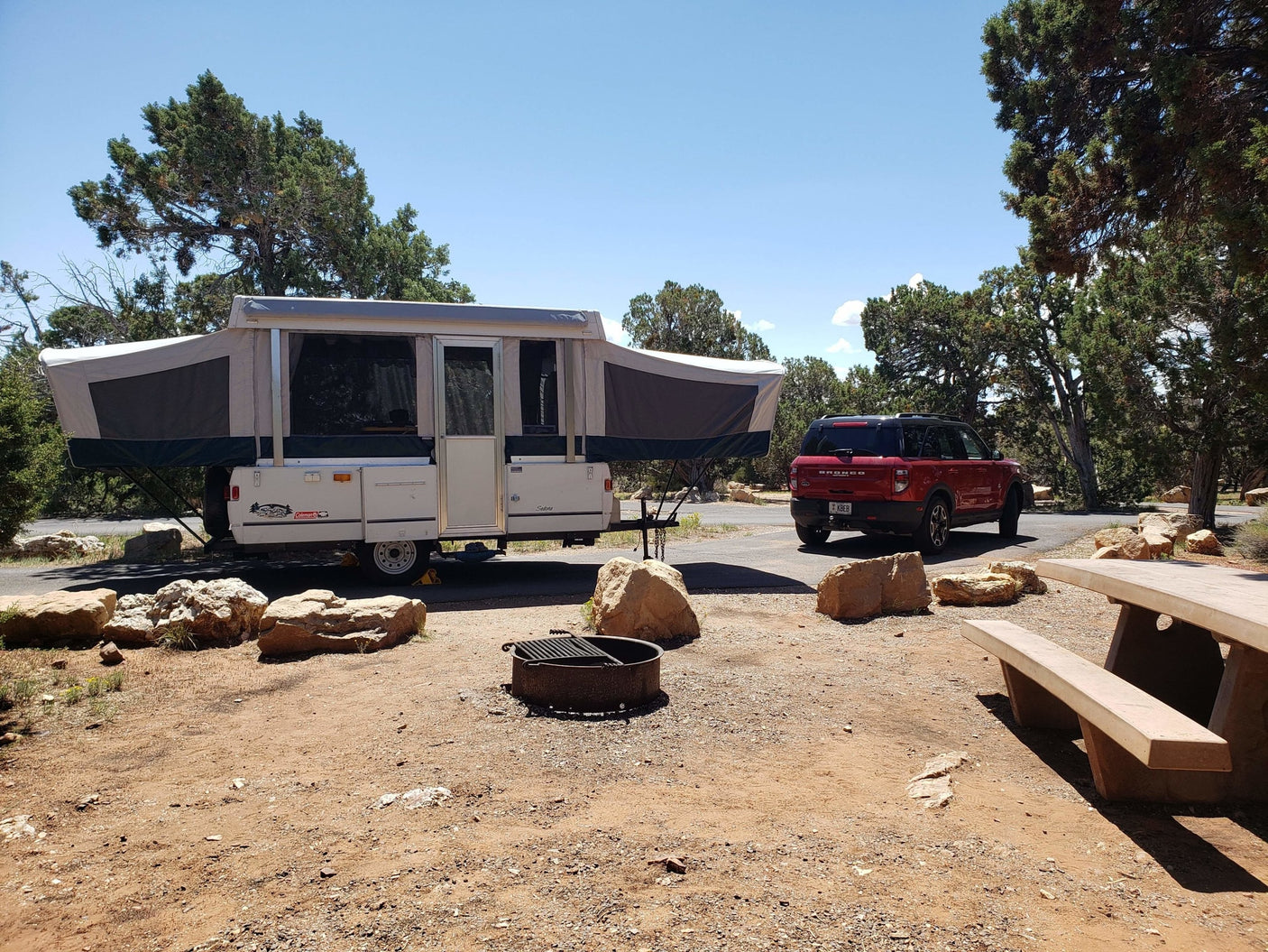 and a comfortable pop-up bunk bed.|Spacious RV rental pop-up camper interior. Two distinct bed areas with ample curtains and storage are visible.|Cozy RV rental pop-up camper interior