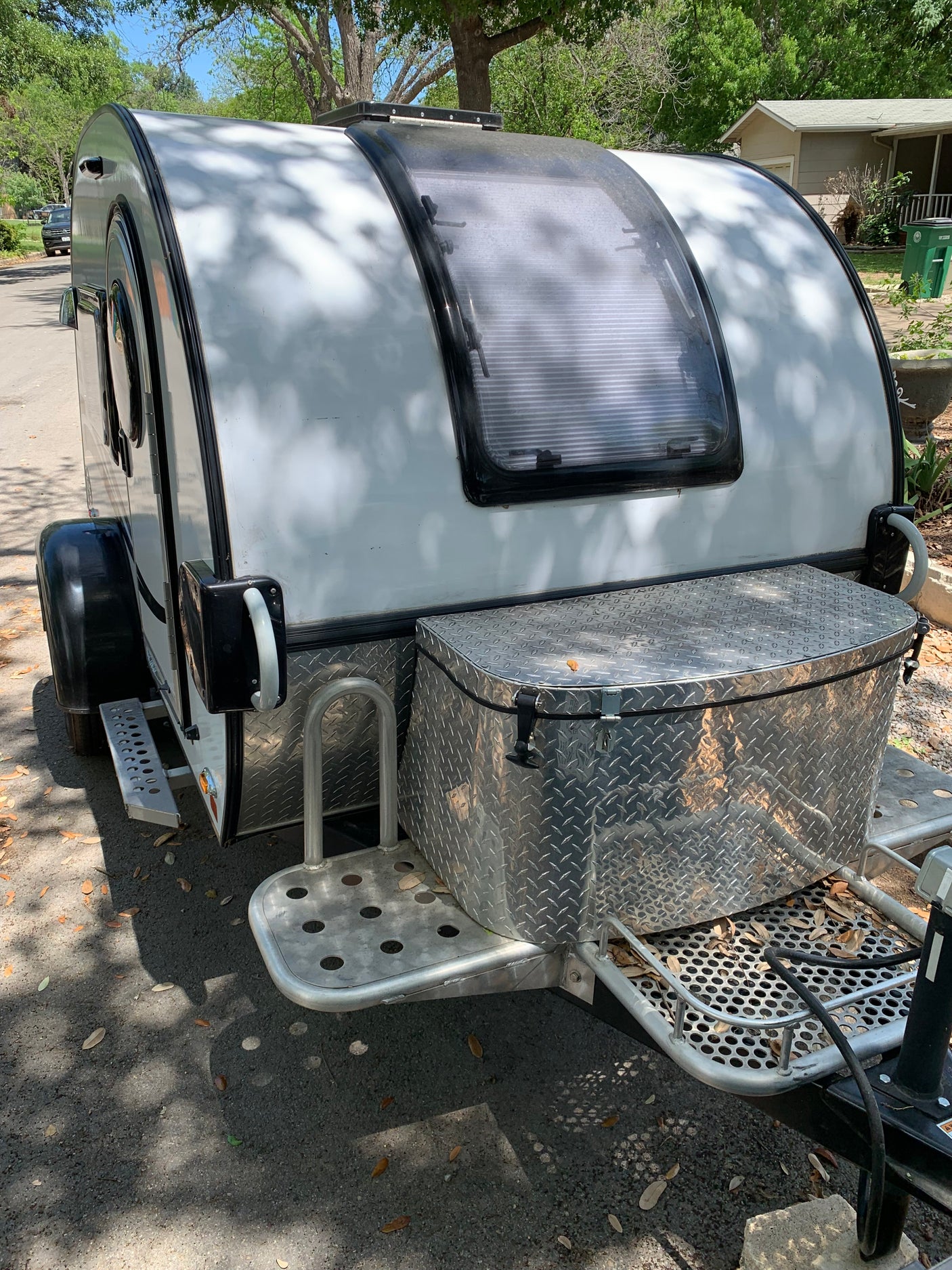 This compact teardrop RV rental, featuring a front storage box and skylight, is ready for your next adventure.