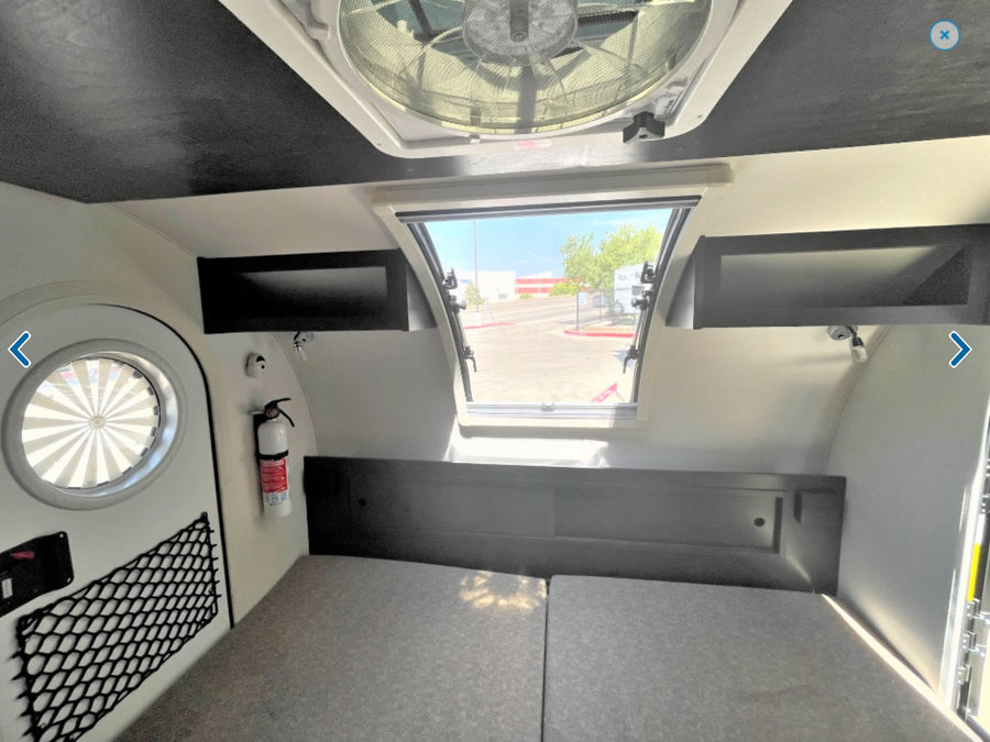 & counter space. Ready for adventures!|Inside an RV rental: a camper bedroom with mattresses