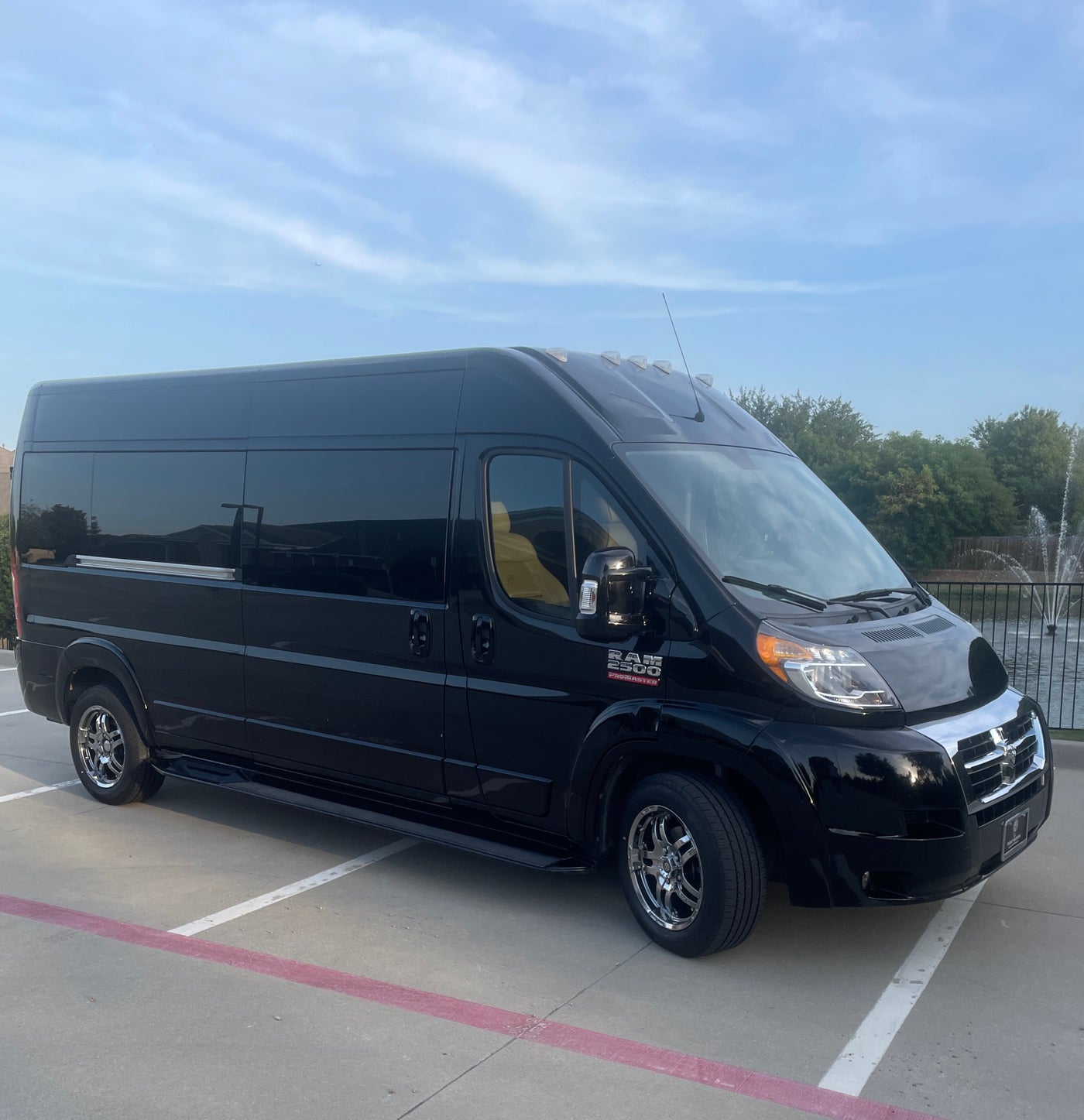 Luxury black RAM Promaster van, suitable for rv rental. A spacious travel vehicle parked under a blue sky. — photo 1