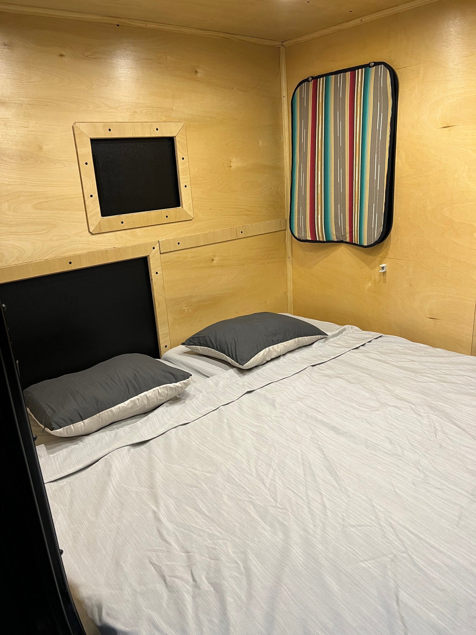 and lights ready for adventure!|Ready for adventure! Open RV rental hatch reveals an outdoor kitchen. Portable table with bowls & cups