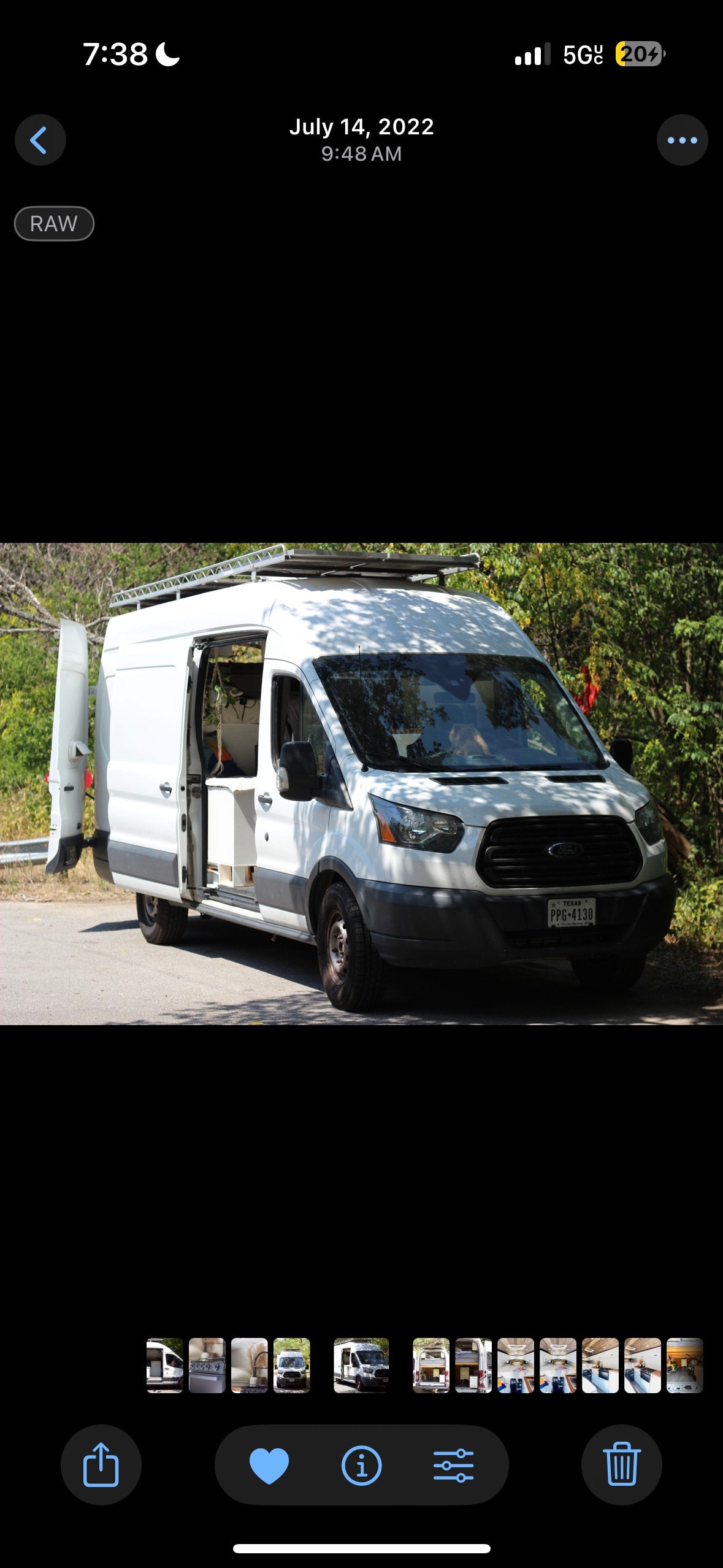 Explore with this Ford Transit camper van, available for RV rental. White exterior, open side door reveals interior. Texas PPG-4130.