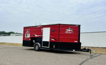 & TV. Cozy mobile living space.|Spacious RV rental interior with wood paneling