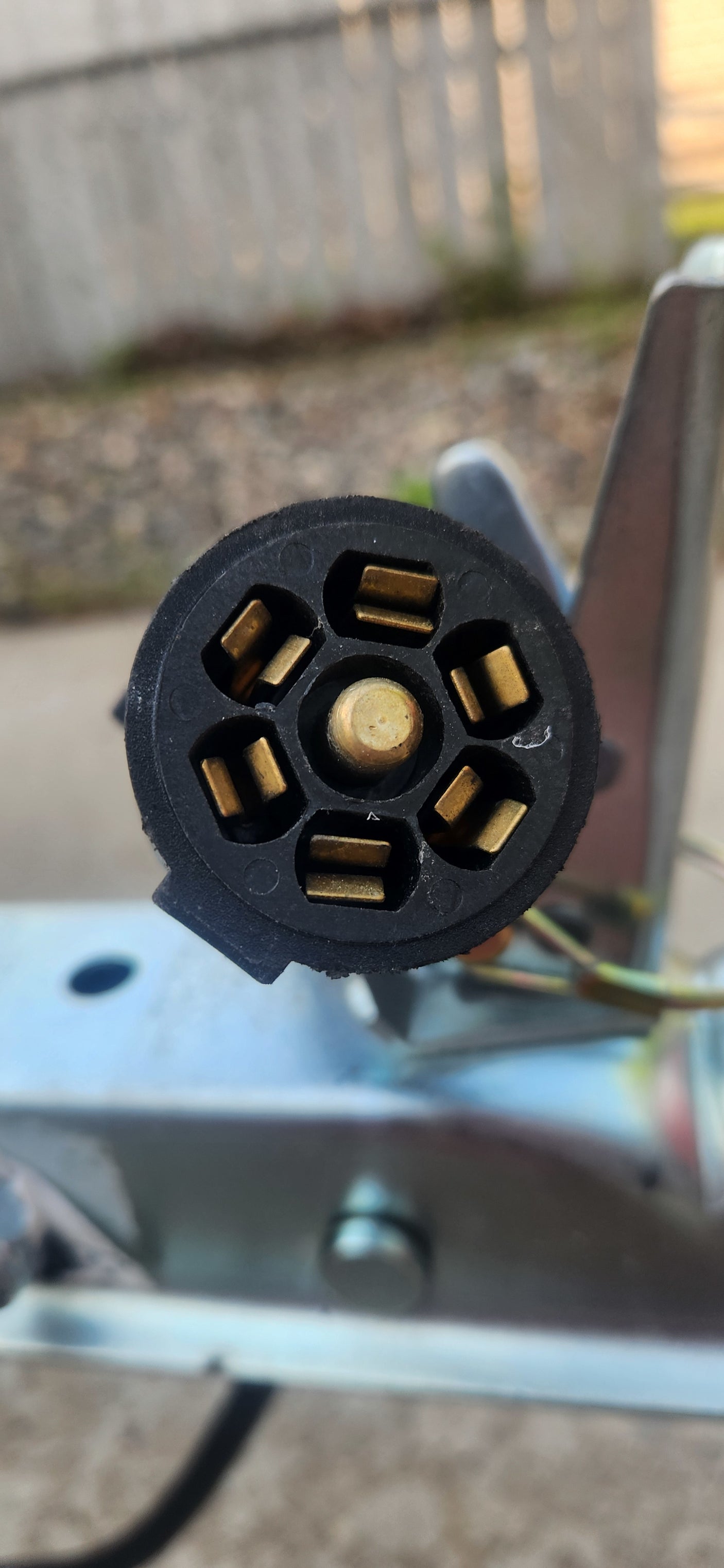 This close-up shows a 7-pin trailer electrical connector, essential for RV rental towing, providing lights and power.