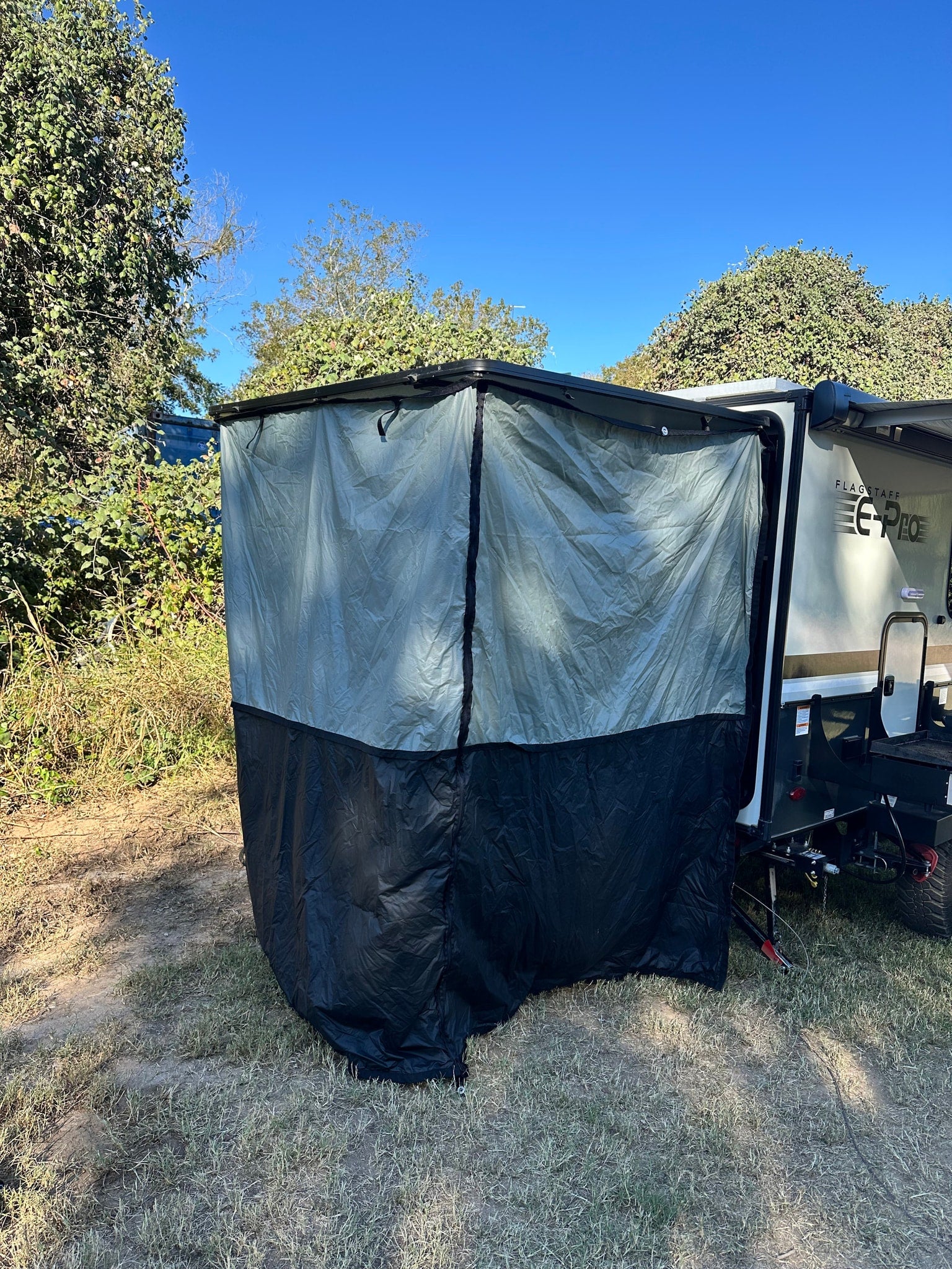 This Flagstaff E-Pro RV rental showcases an attached outdoor privacy room, perfect for enhanced camping or shower use.