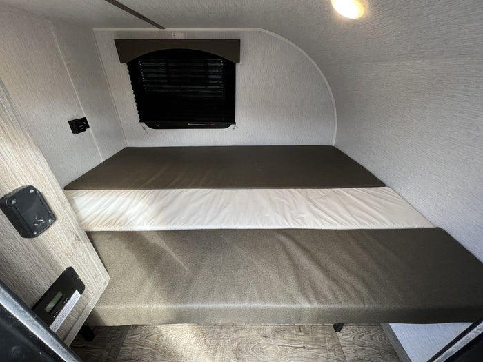with a white camper van behind.|View of an RV rental's black