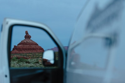Stunning desert vista from an RV rental. A towering red rock formation framed by the open door of a white RV. — photo 15
