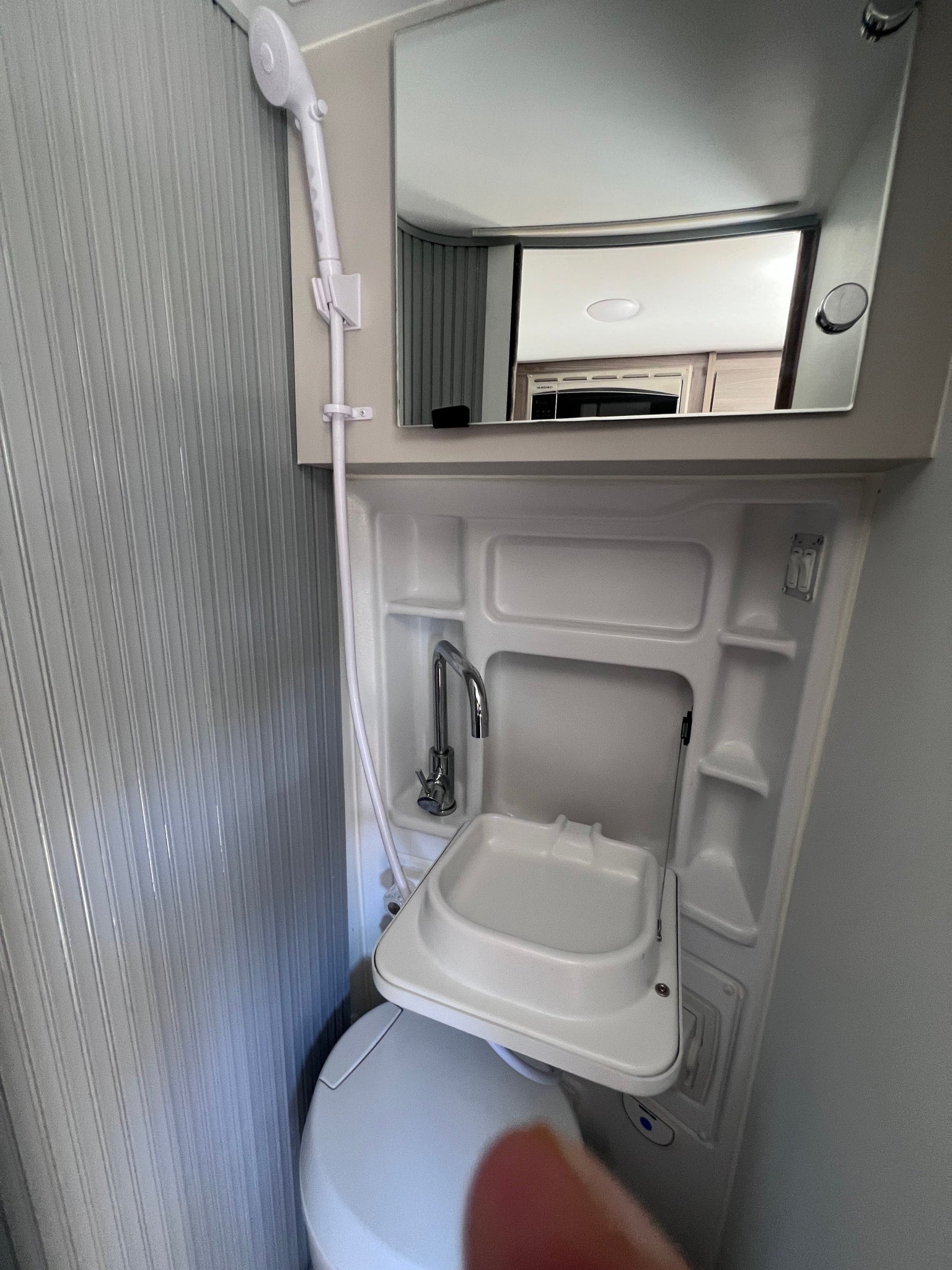 and a comfortable sleeping area with windows.|An RV rental interior shows day seating with forest views & transforms into a cozy bed for amazing stargazing.|This RV rental interior features safety controls