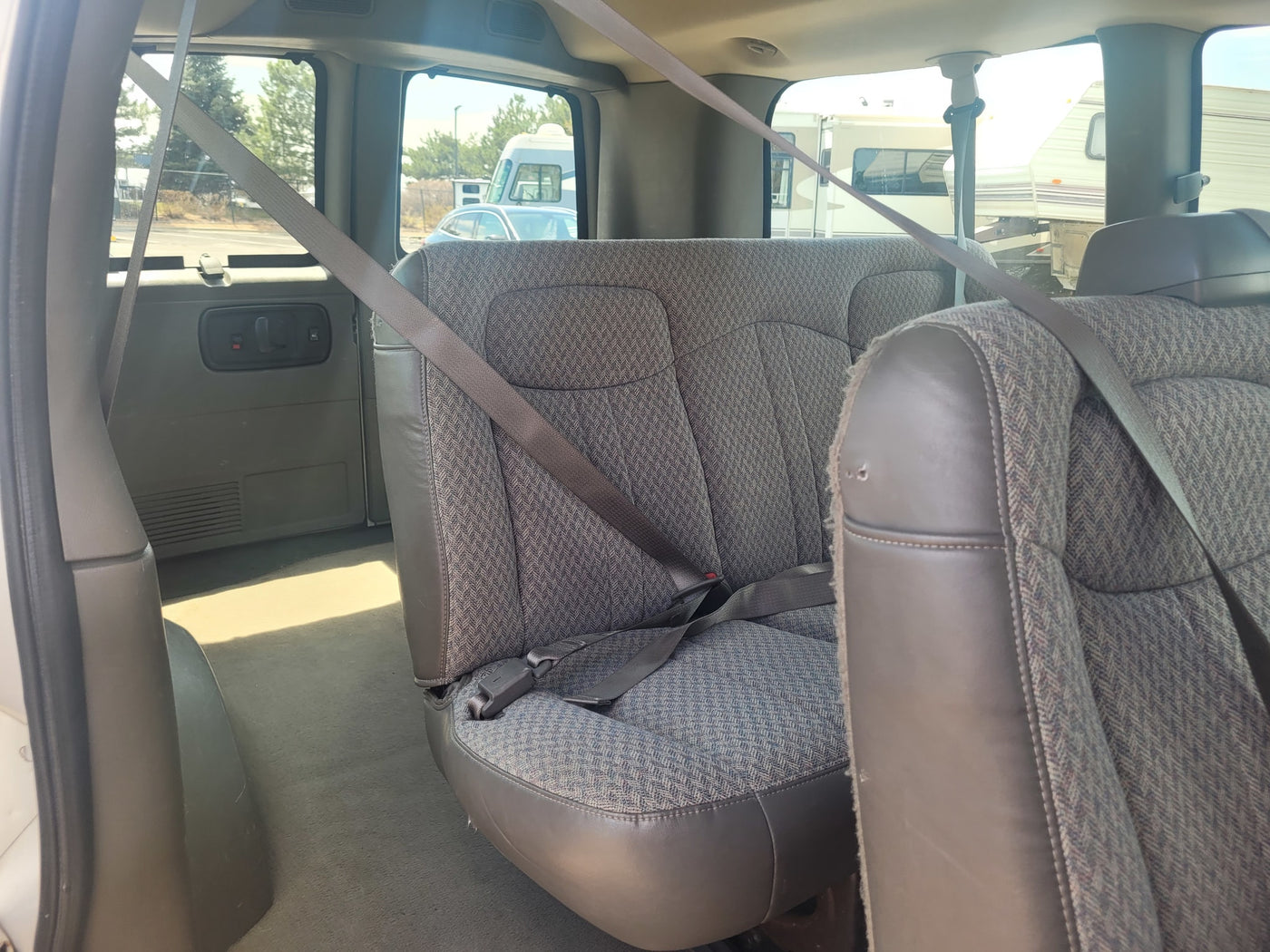 ideal for your next RV rental.|Inside a white commercial van with steering wheel & seats — photo 11