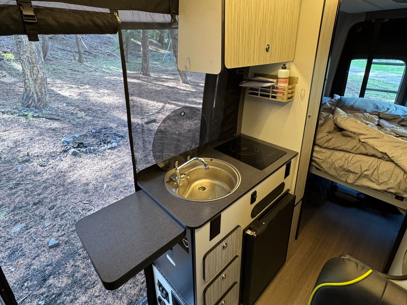 Step inside this RV rental, featuring a compact kitchen with sink/cooktop, extendable counter, and a comfy bed. Enjoy nature!