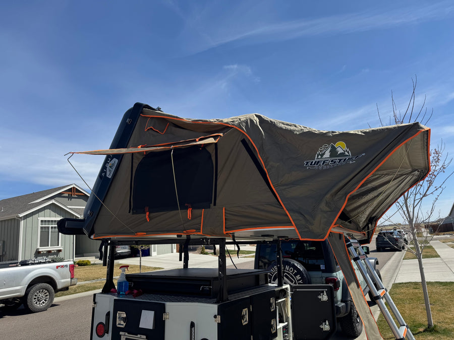 Overland rooftop tent deployed on a camping trailer & Jeep. Perfect compact RV rental for adventure.