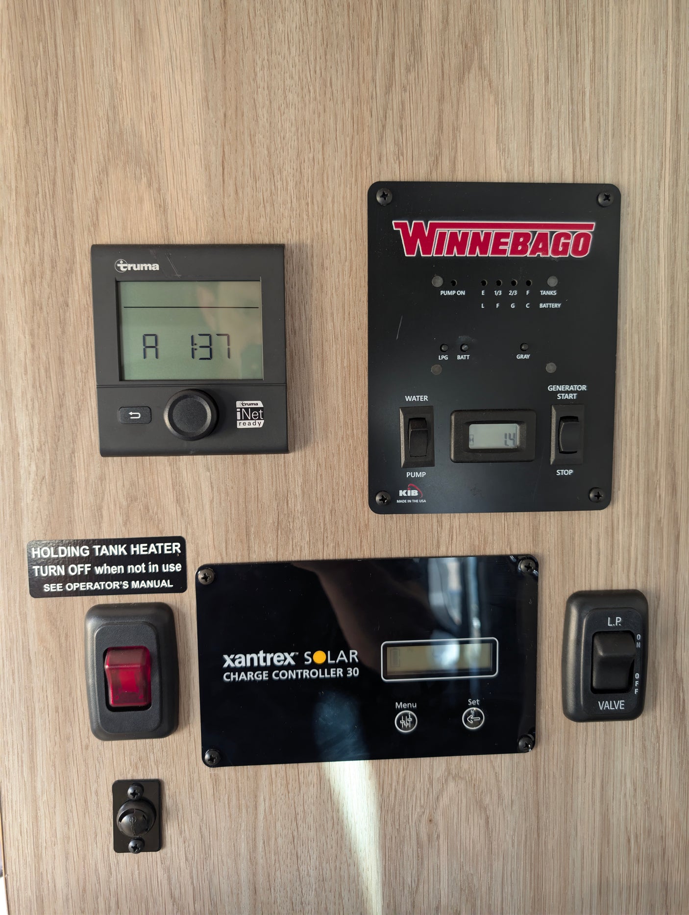 RV rental control panel: Truma heater, Winnebago tank/generator controls, Xantrex solar charger, tank heater, LP valve.