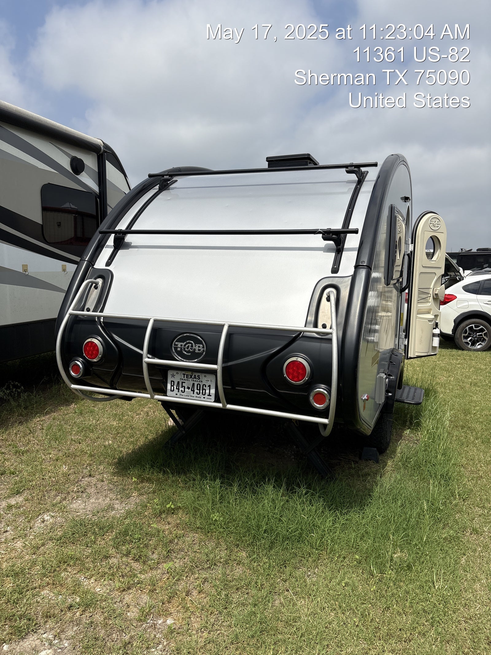 Compact T@B travel trailer, perfect for your next RV rental adventure, parked on grass in Texas.