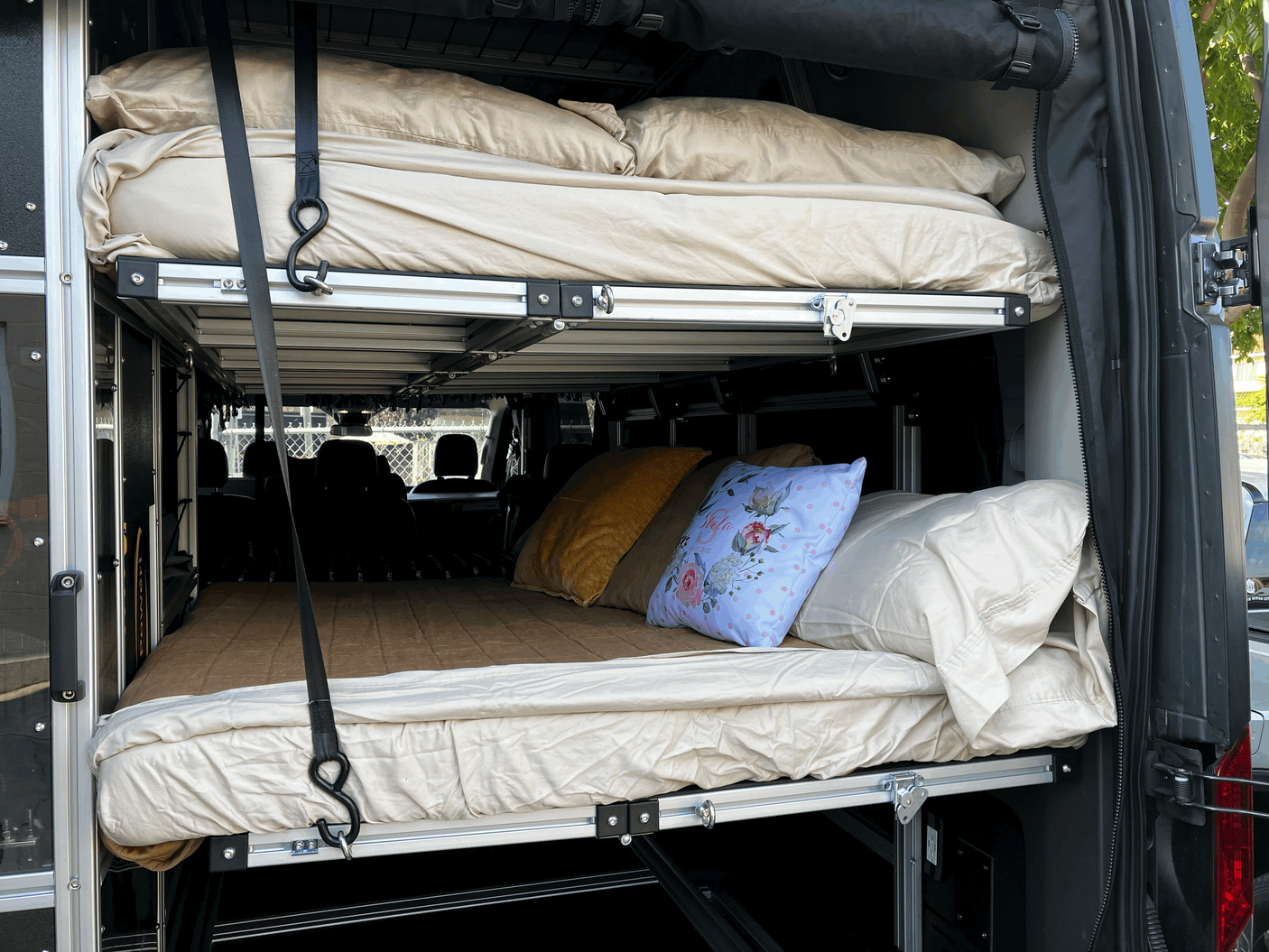 Modular rv rental interior: A two-tier bunk bed system with cozy bedding, ready for your next adventure.