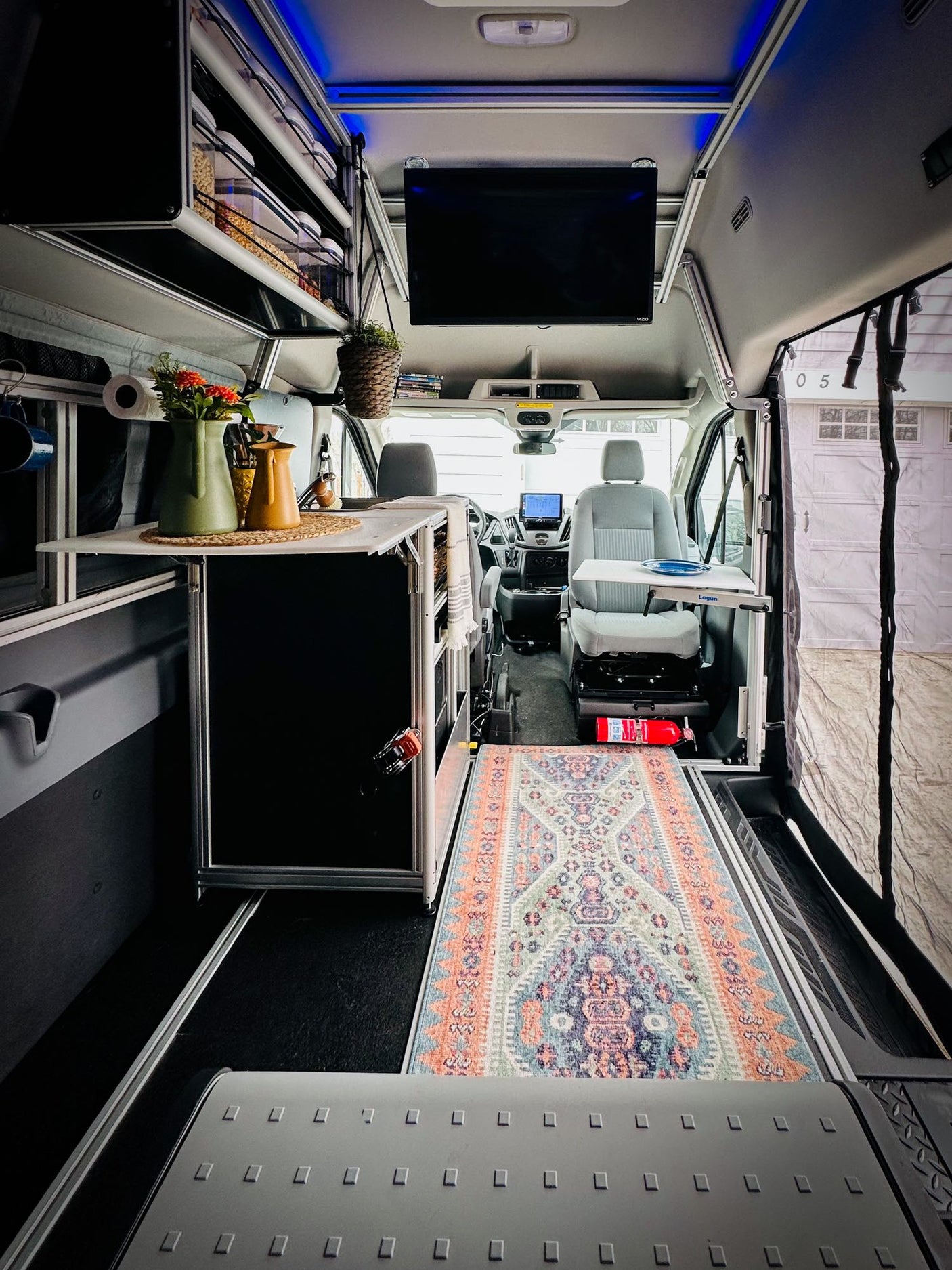and a versatile Lagun table for comfortable travel.|Cozy RV rental interior: compact kitchen area