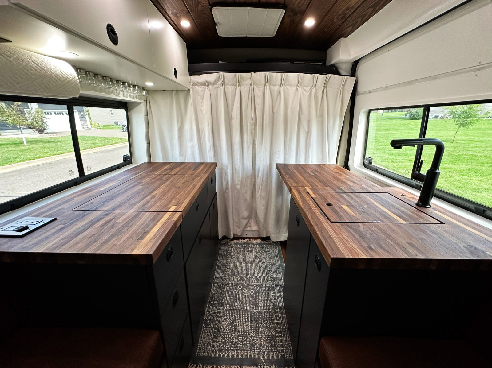 and comfy seating in a sleek camper van.|This RV rental van interior features a modern kitchen