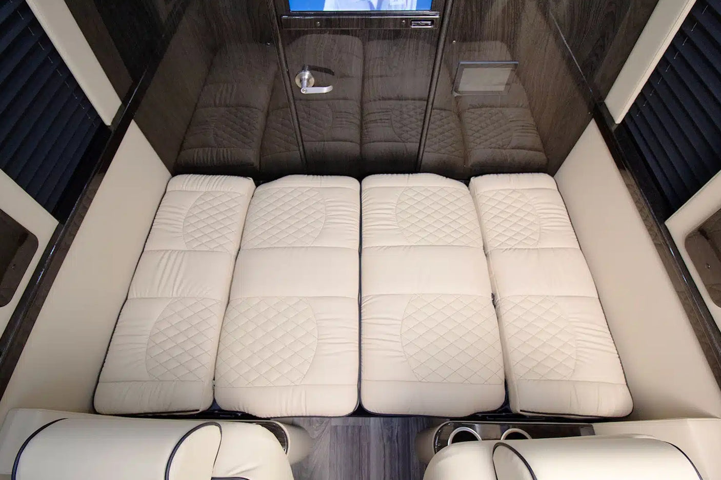 RV rental: View of a luxurious sleeping area with four quilted white mattress sections inside the cabin.