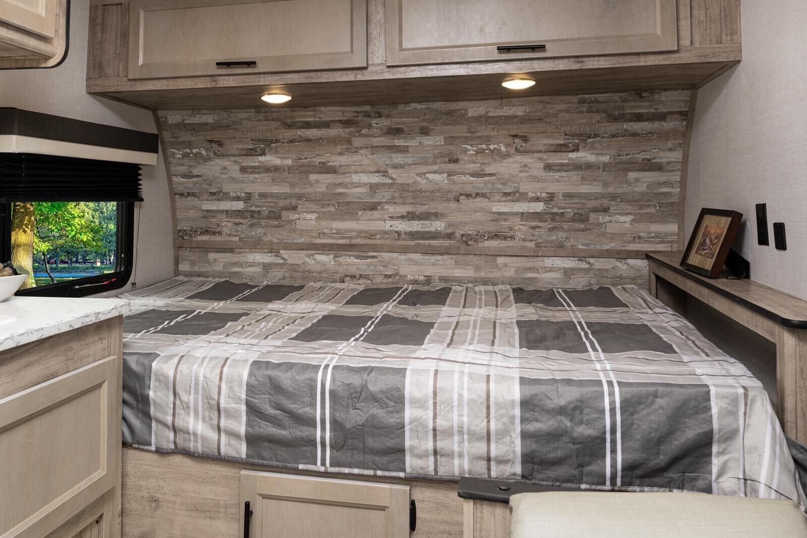 and propane tank for outdoor adventures.|RV rental: Modern RV living area with a comfortable gray sofa