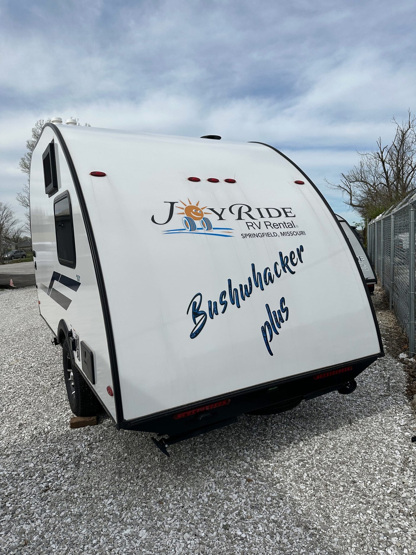 White Bushwhacker Plus travel trailer, available for rv rental from Joy Ride RV Rental. Ready for your next adventure!