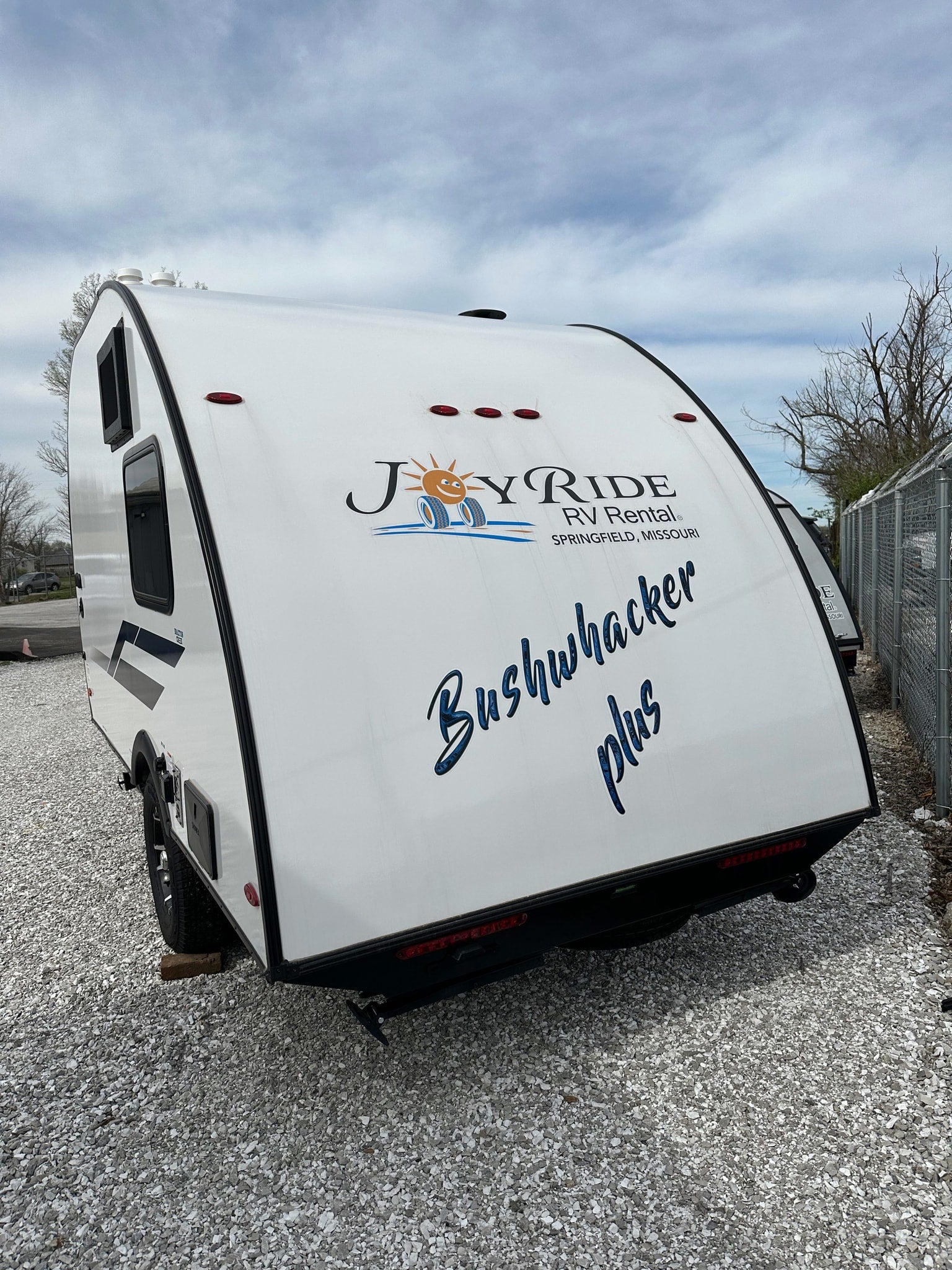White Bushwhacker Plus travel trailer, available for rv rental from Joy Ride RV Rental. Ready for your next adventure!