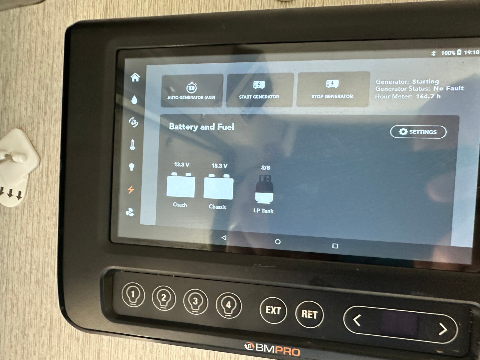 On an RV rental, this BMPRO panel shows generator info (164.7h), battery (13.3V), and LP tank (3/8) levels.