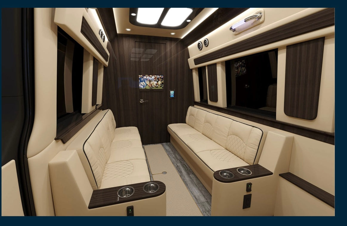 wood table & elegant paneling.|This RV rental offers a luxurious and spacious interior with cream leather seating