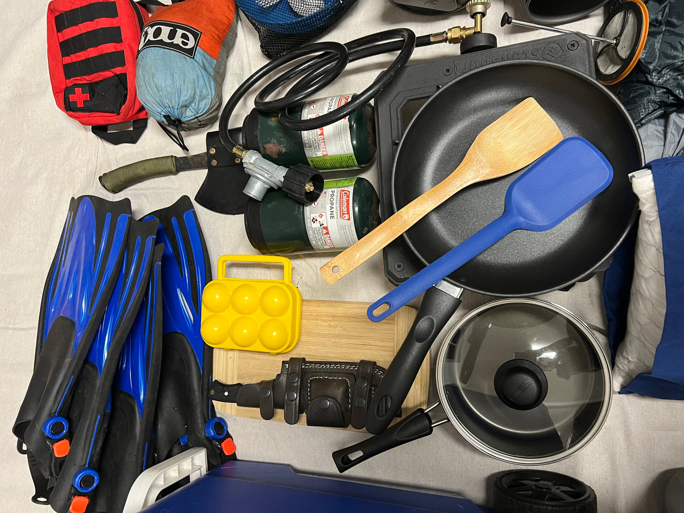 RV rental essentials: Camping gear, cooking supplies like propane, pans, first aid kit, and diving fins for adventure.
