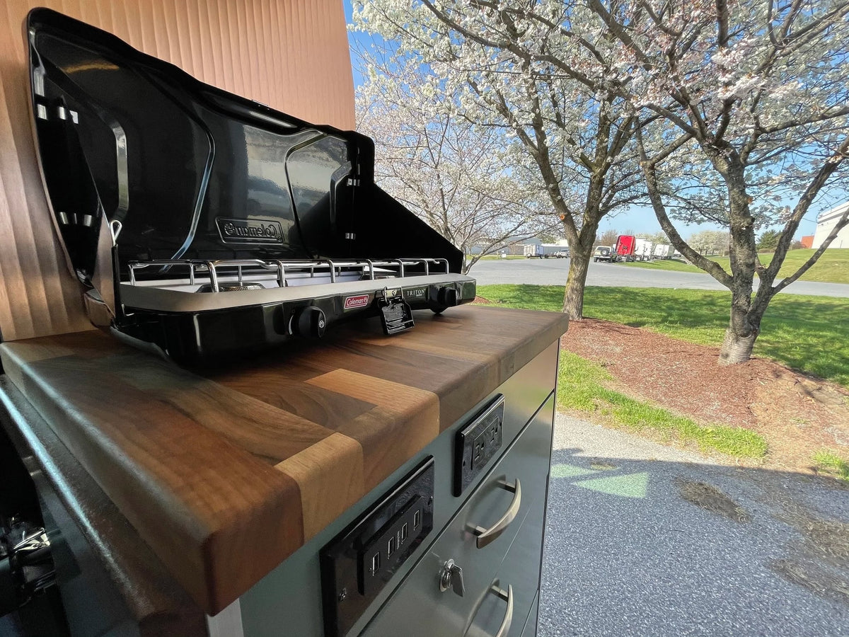 and wooden accents.|RV rental: Open refrigerator revealing compact interior — photo 3