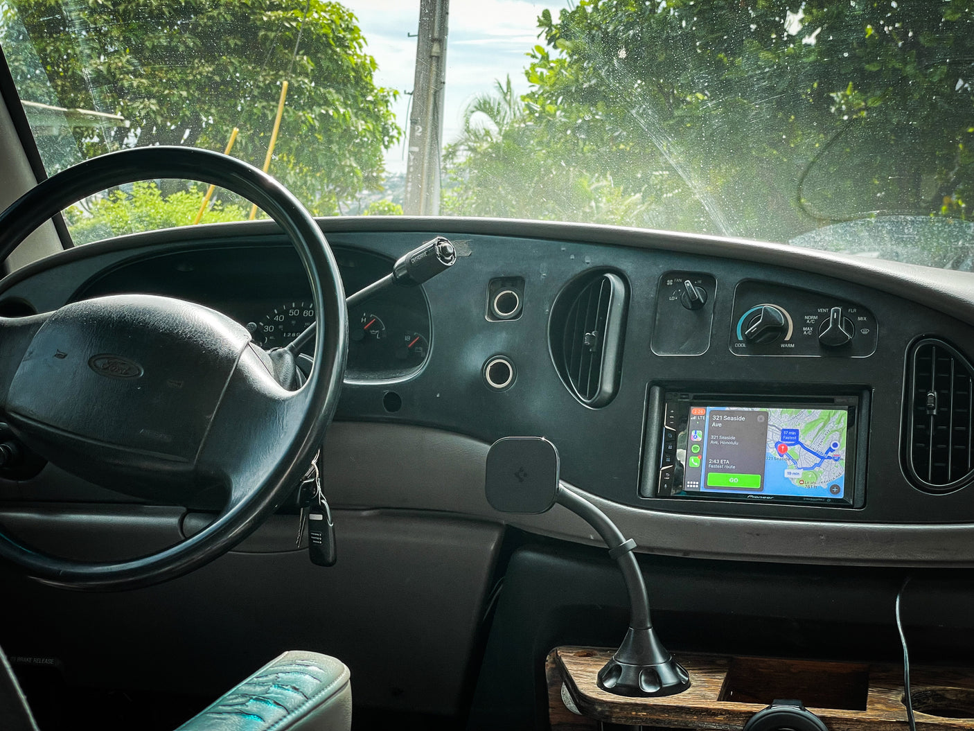 Inside an RV rental: Dashboard view with Ford steering wheel, keys, and a GPS navigating to Honolulu, Hawaii.