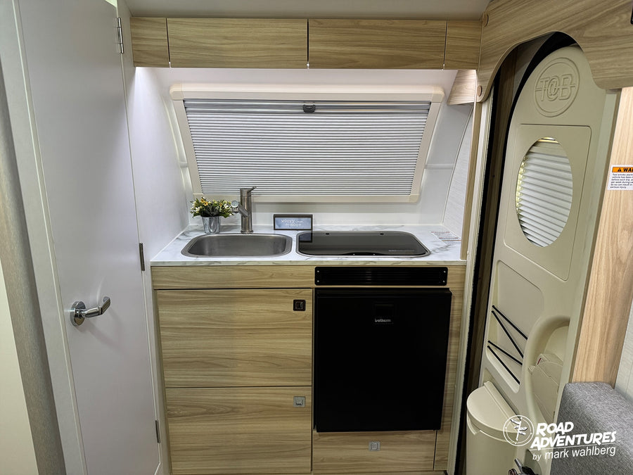 is ready for adventure with its striking red and white design.|A shiny nuCamp teardrop travel trailer