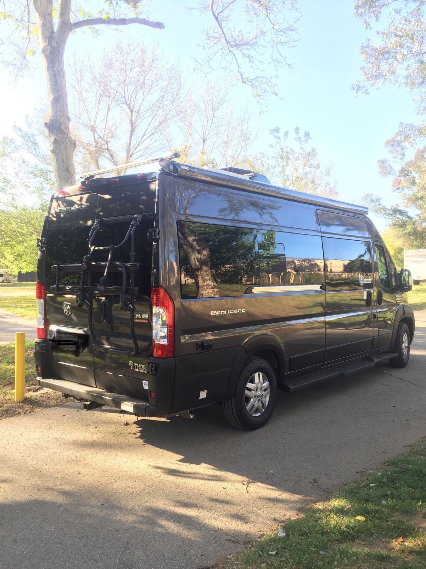 Sleek Class B RV rental, a Thor Sequence camper van on a Ram ProMaster chassis, with a Thule bike rack.