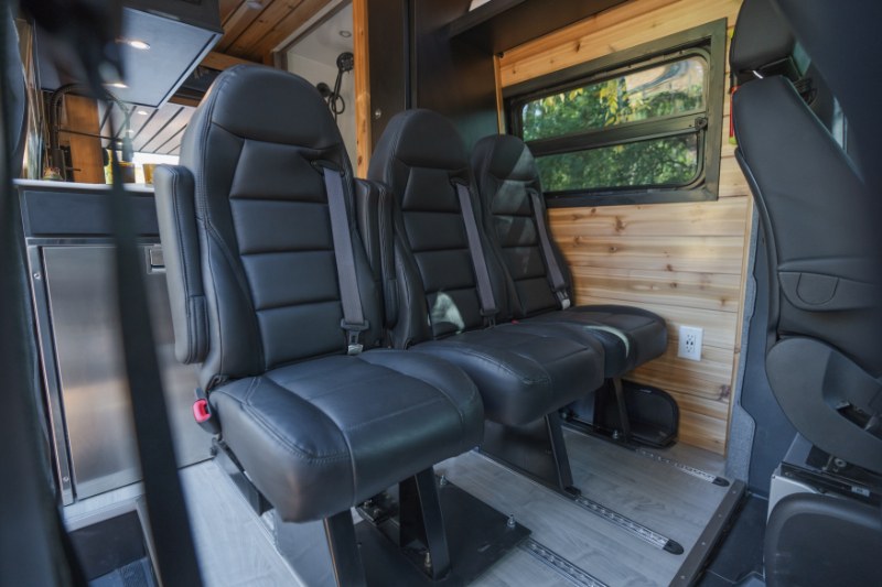 ideal for your next rv rental adventure.|Front view of a dark Mercedes Sprinter camper van with pop-top extended