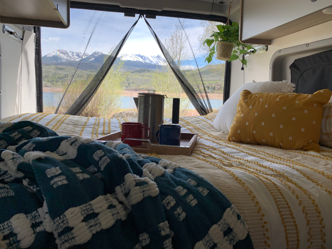 Your RV rental adventure starts here! Enjoy cozy comfort, coffee, and stunning mountain & lake views from bed.
