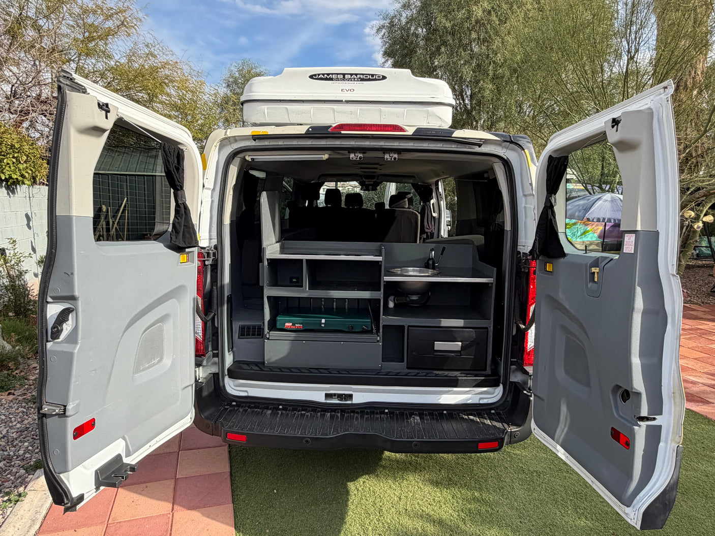 RV rental: Get a glimpse inside this camper van's rear kitchen, storage, and James Baroud rooftop tent.