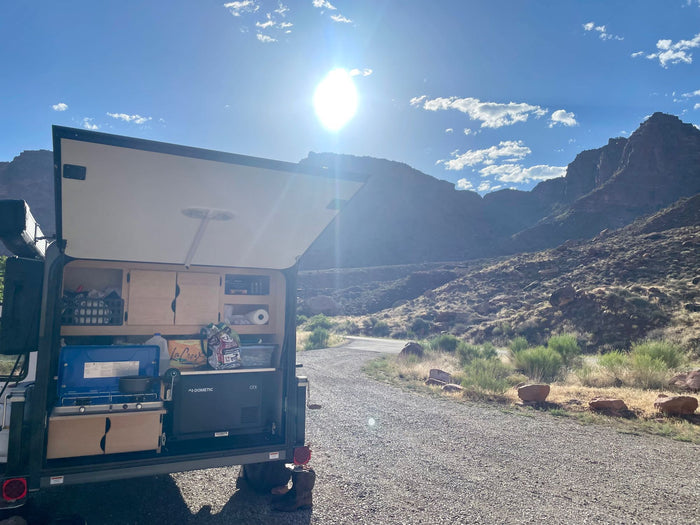 mountainous desert scenery.|Cozy RV rental interior with a bed