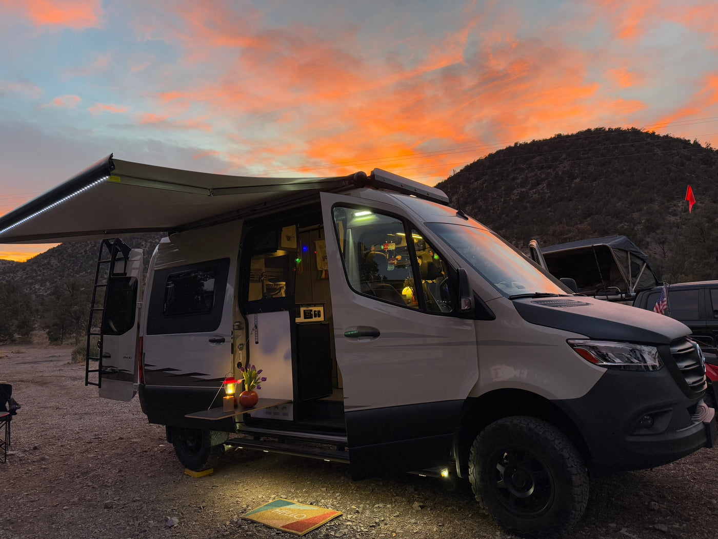 Gorgeous sunset over an RV rental camper van campsite. Awning extended — photo 21