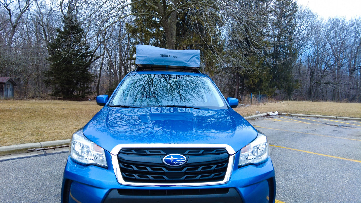 This blue Subaru Forester with a Thule Tepui roof-top tent offers a compact RV rental experience for outdoor adventures. — photo 9