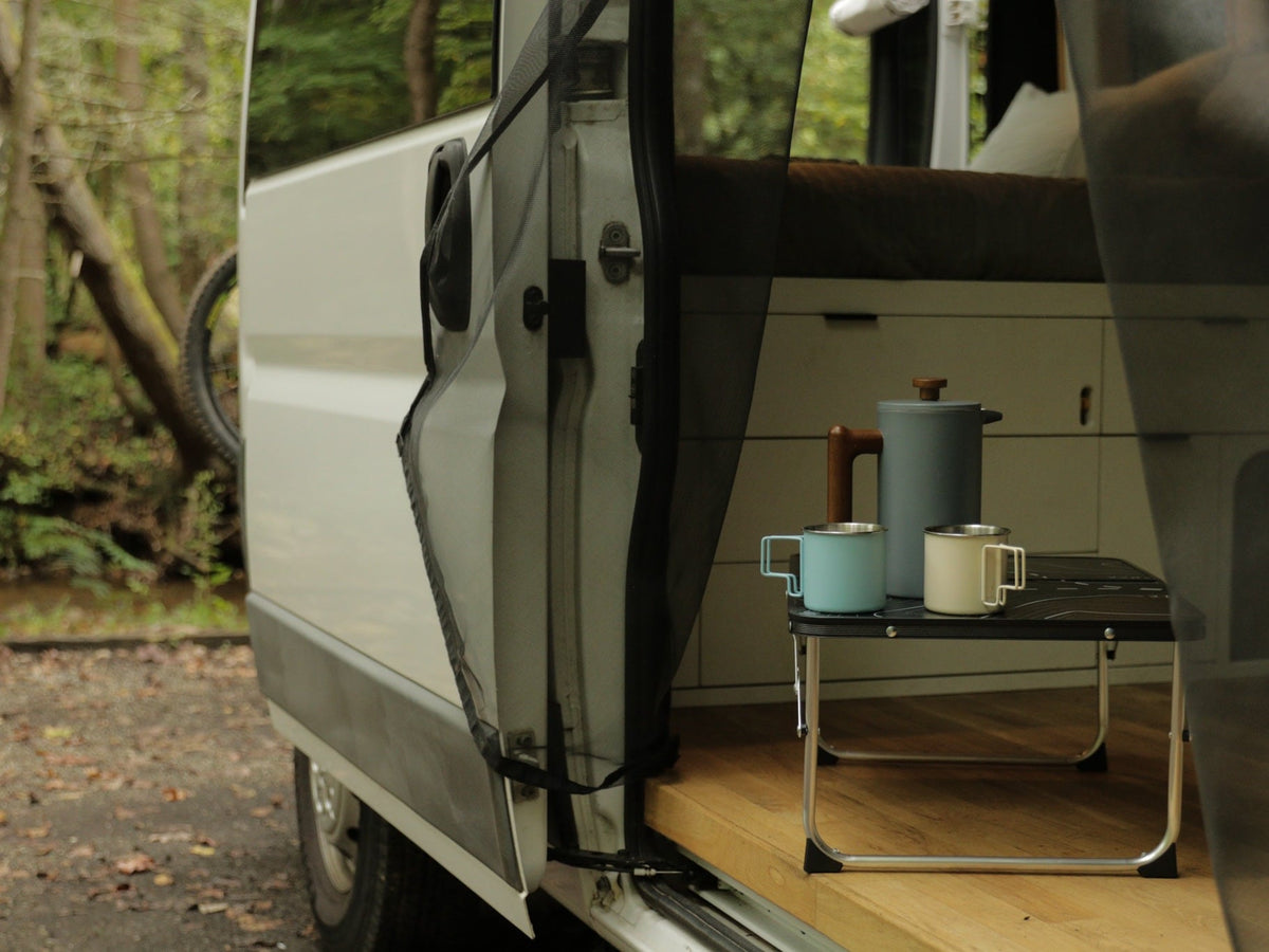 perfect for campsite meals.|Hand pours coffee from a sleek pot into a mug inside an rv rental — photo 8